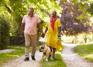 Couple walking dog in the woods