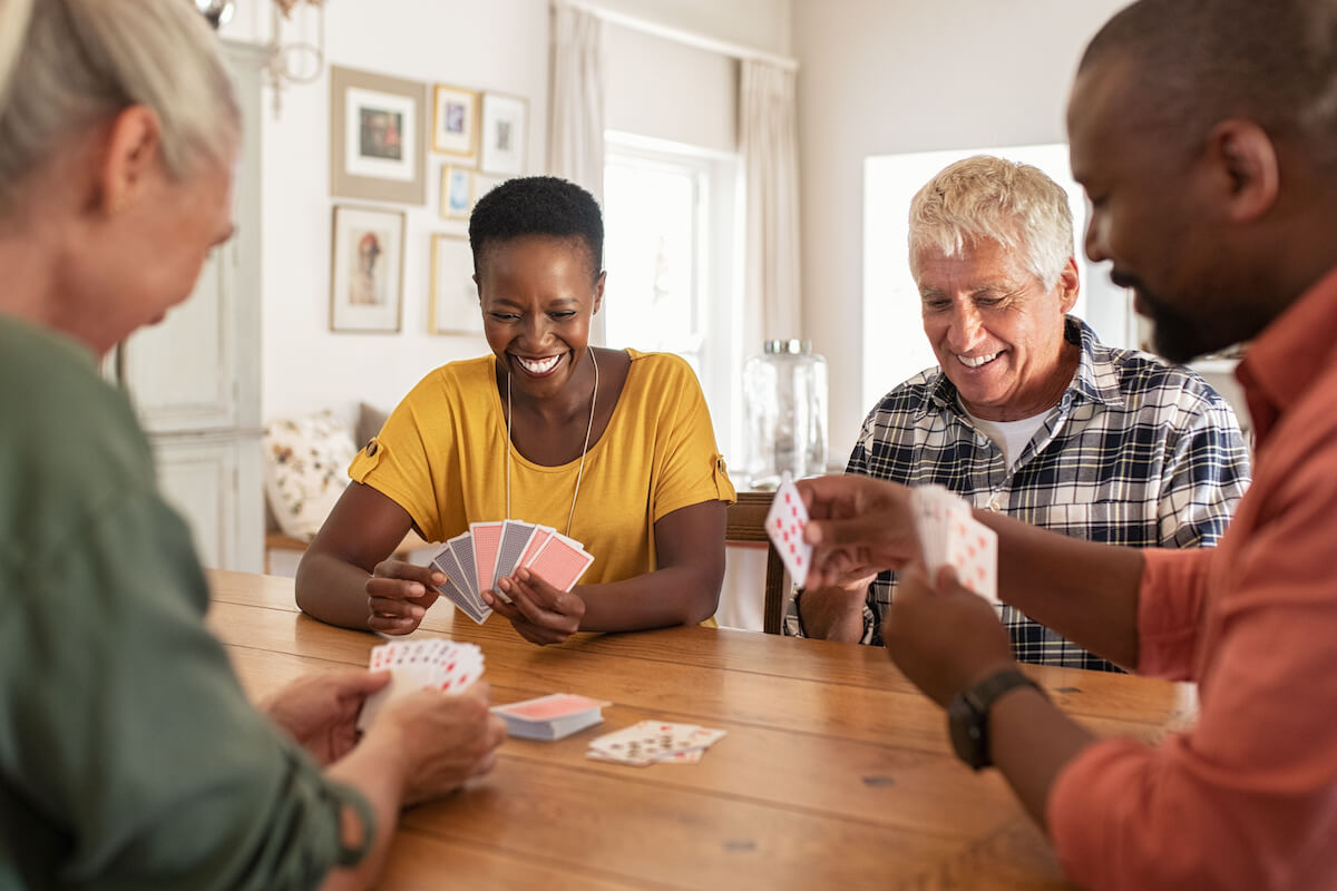 Group of seniors playing cards together