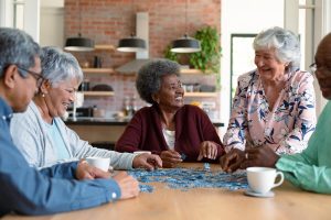 Group of happy seniors gathered in a table.