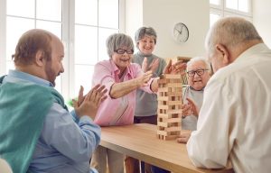 Group of seniors playing Jenga together