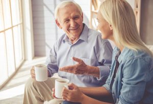 Daughter Talking to Her Father and Drinking Coffee