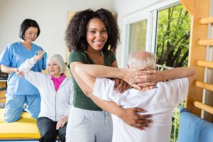 Caregivers giving fitness class to older adults