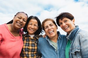 Group of multi-cultural friends taking a picture together.