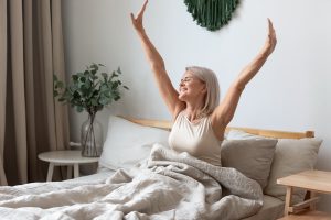 Joyful older woman waking up