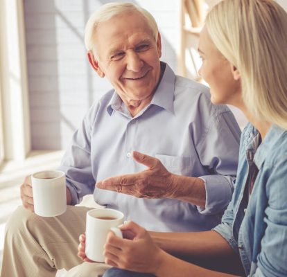 Daughter Talking to Her Father and Drinking Coffee